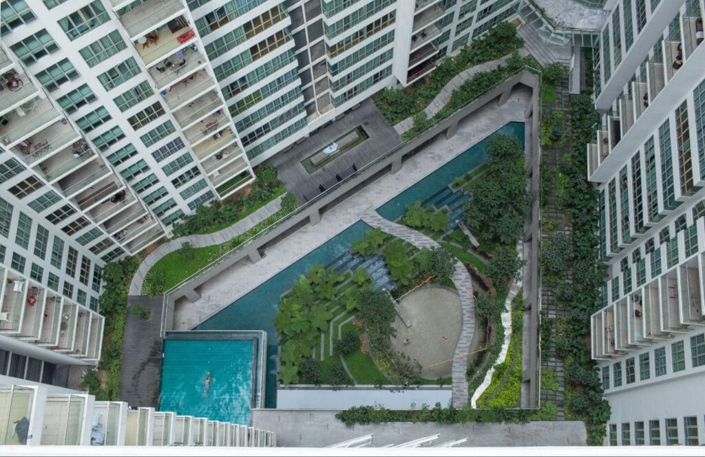 high rise condominium building with pool